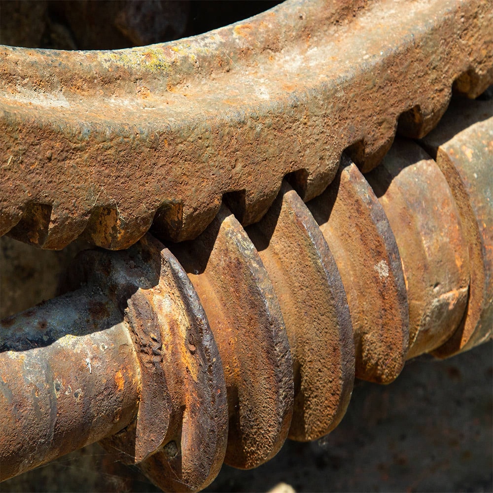 corrosive wear seen on weathered gear and cog