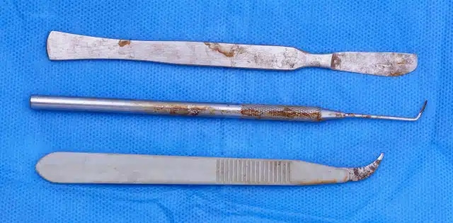 stainless steel medical instruments showing signs of wear