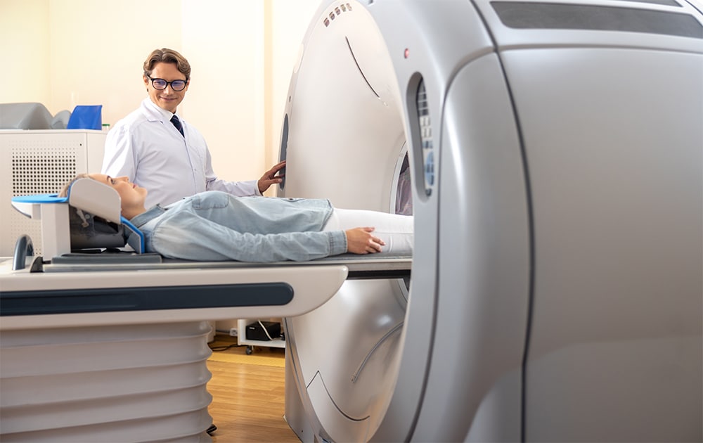 The radiologist is preparing a computed tomography (CT) scanner for a patient.
