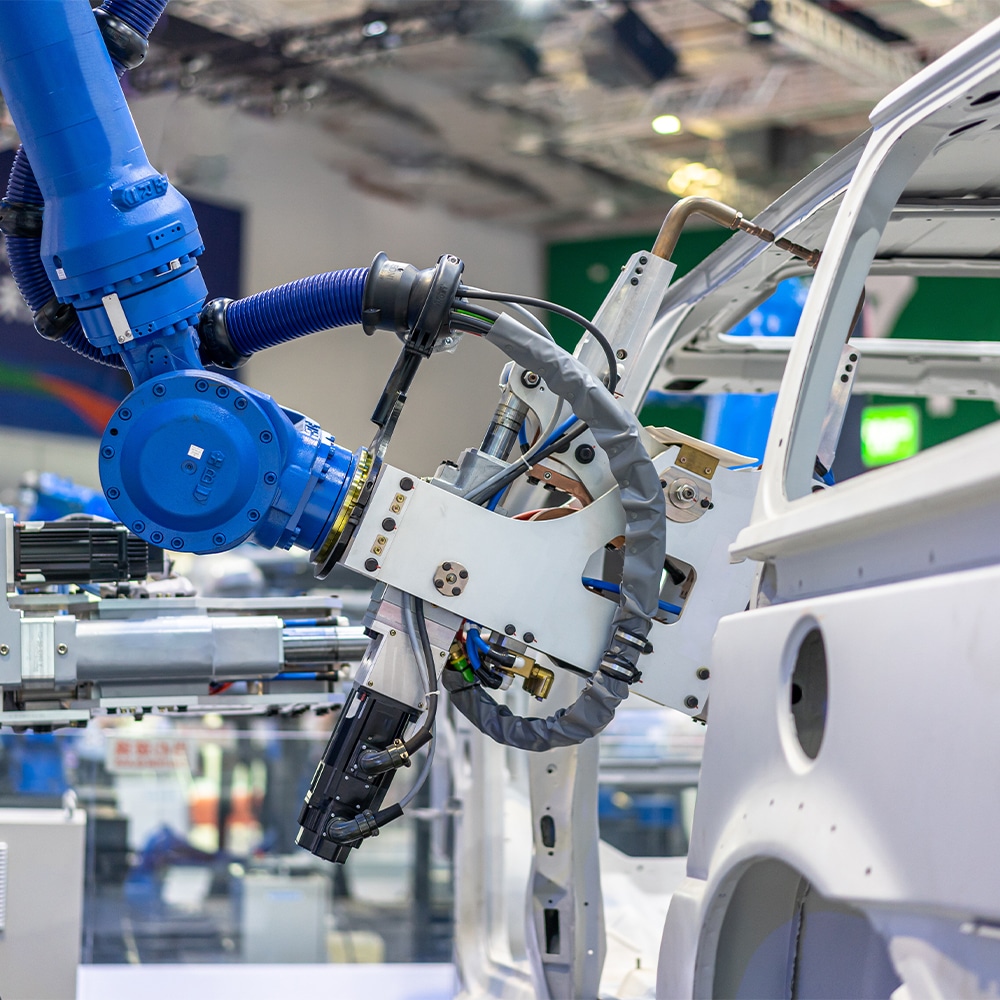 Robot arm working in automotive assembly line that was coated by Armoloy South Africa for wear protection.