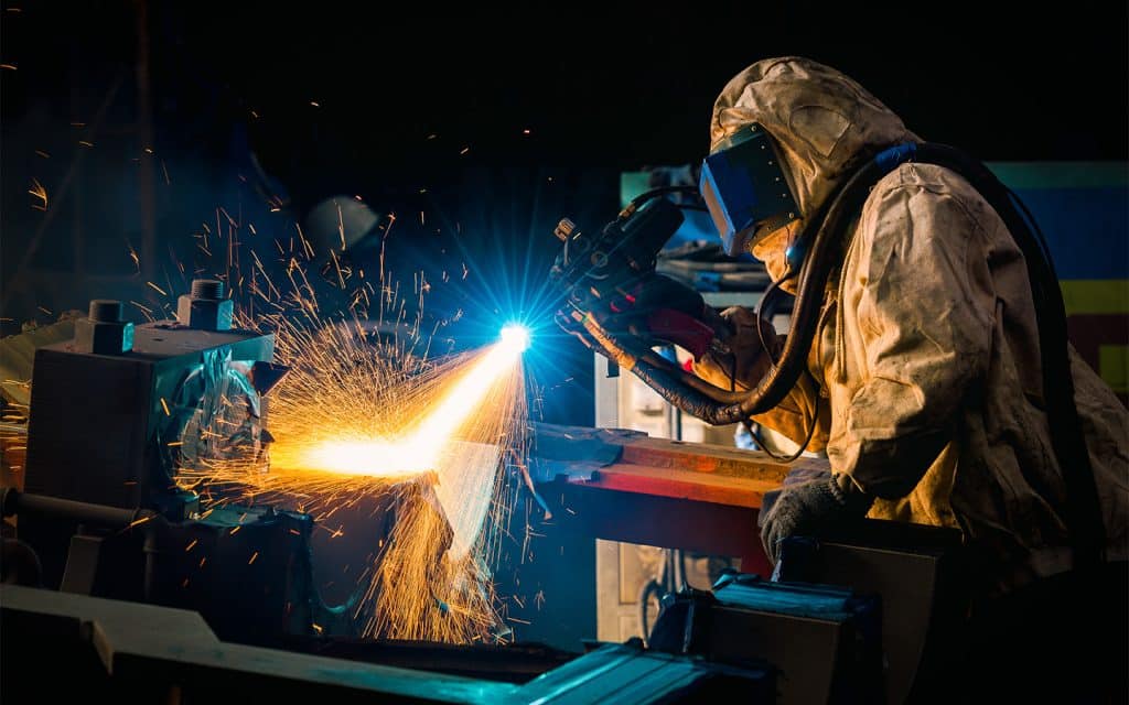 worker conducting thermal spray coating process