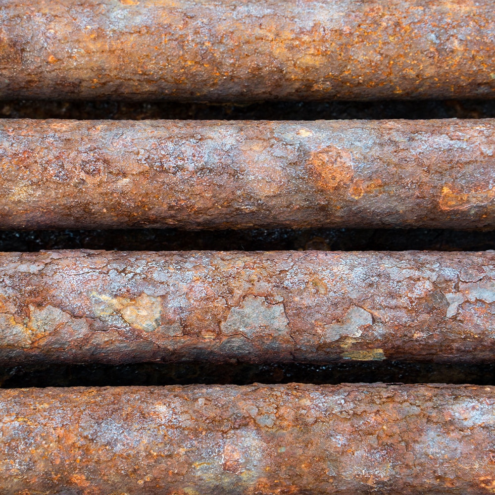 uniform corrosion in the form of rust on old water pipes