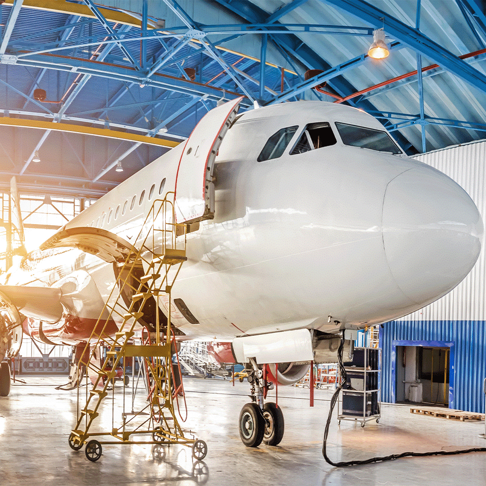 Airplane in hangar, representing AS9100D Quality Management Systems Standard for Aerospace and Defense industries.