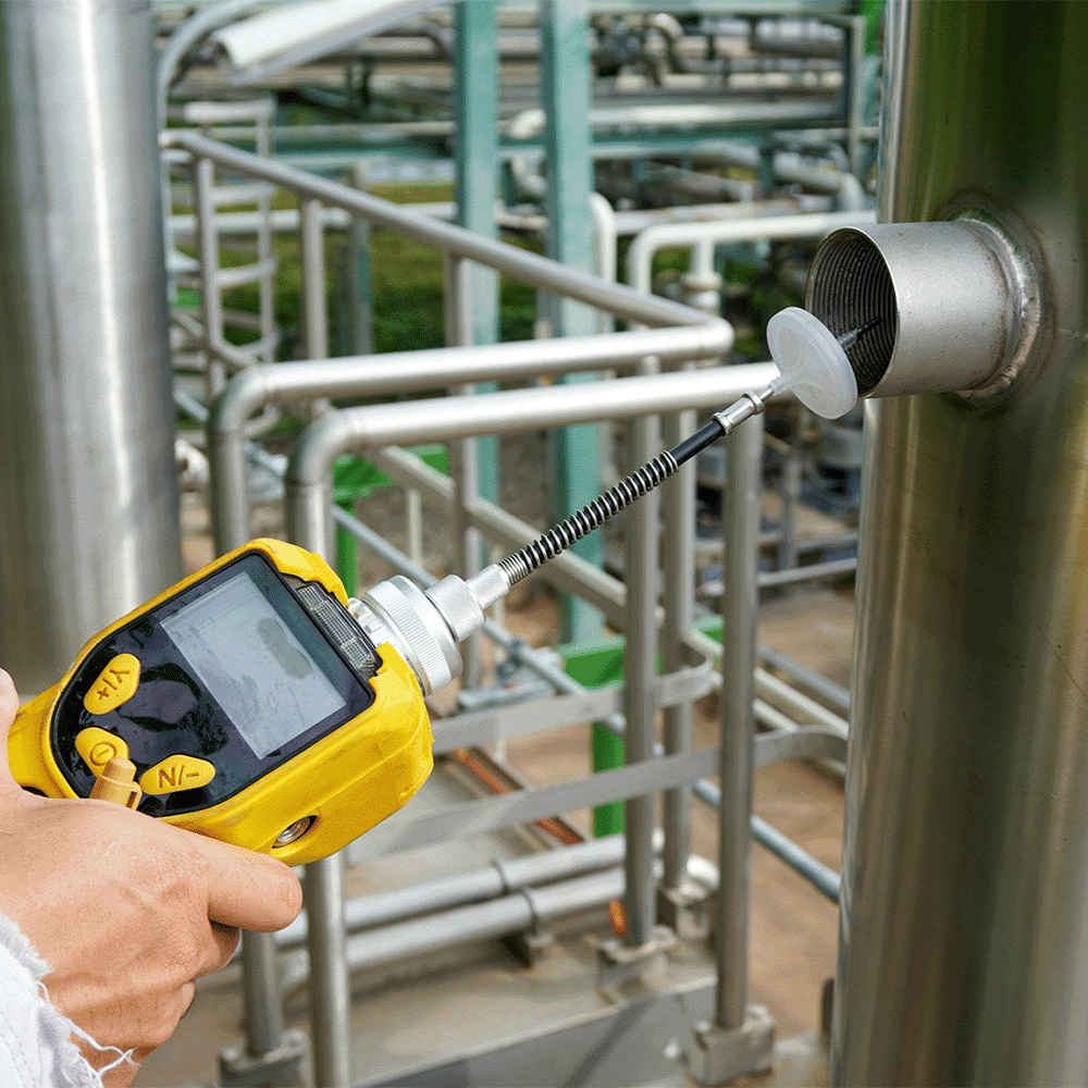 Engineer tests a metal valve per ISO 14001 Environmental Management Systems.