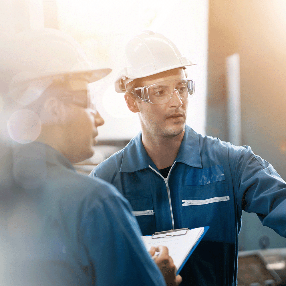 two quality control engineers perform inspections to achieve ISO 9001 certification