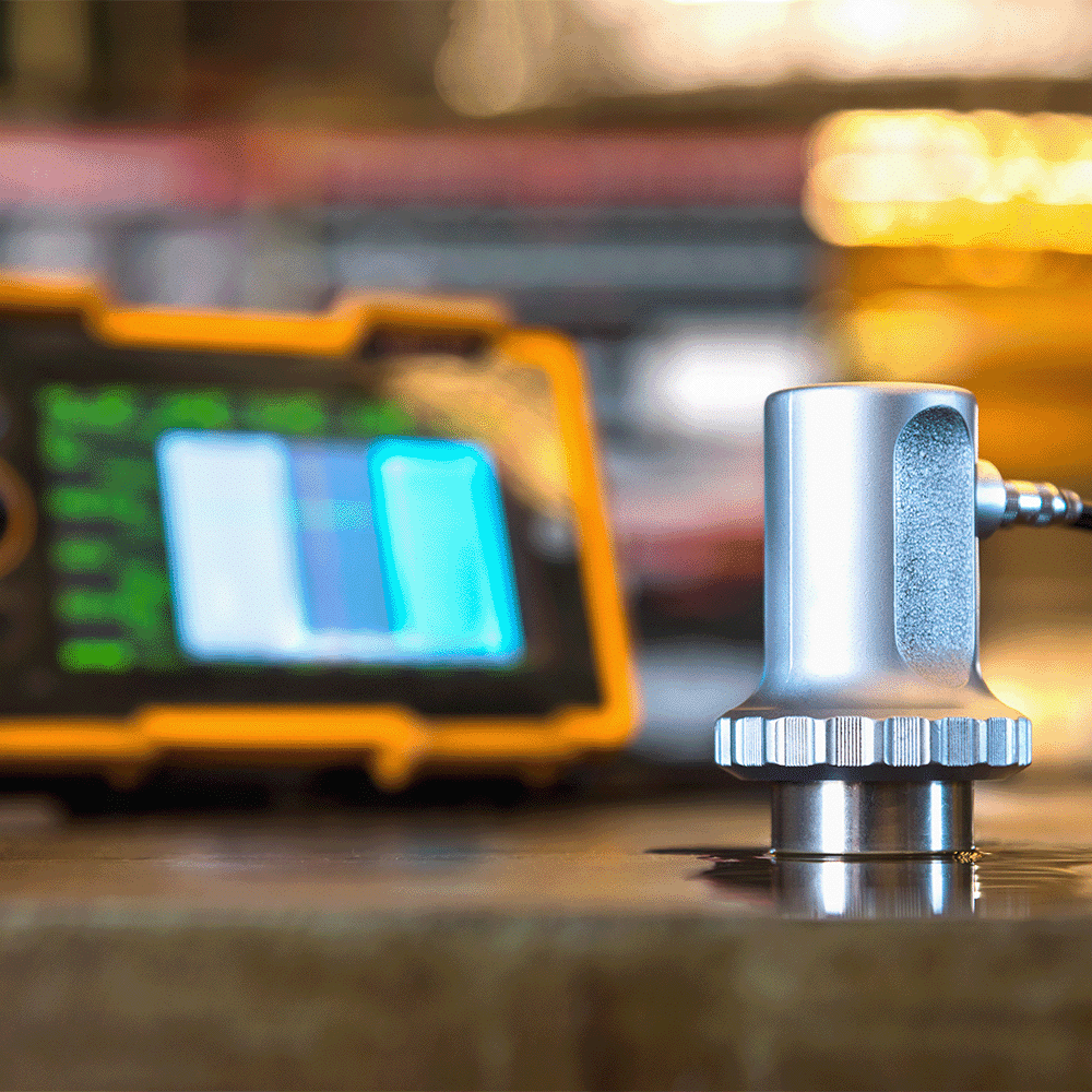 An ultrasonic testing machine detects subsurface pitting corrosion by identifying variations in thickness on a metal surface.
