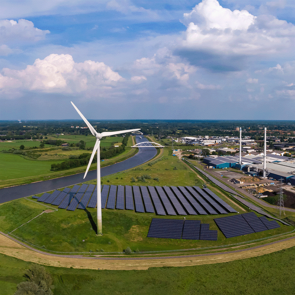 Wind turbines in a European town, representing requirements for achieving ISO 14001 certification for environmental management systems.