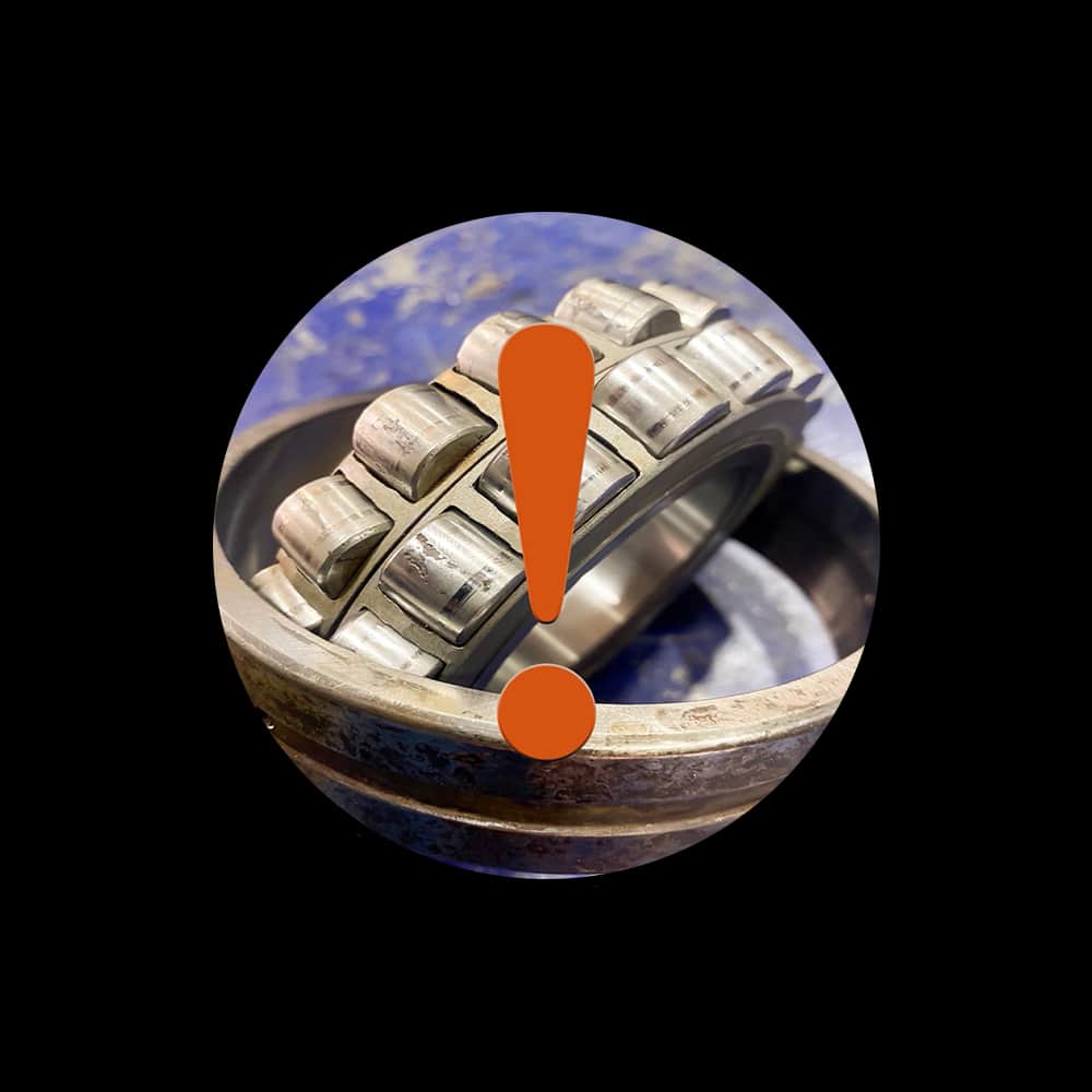 Warning symbol over a close-up of a damaged roller bearing against a black background, indicating a mechanical fault safety alert.
