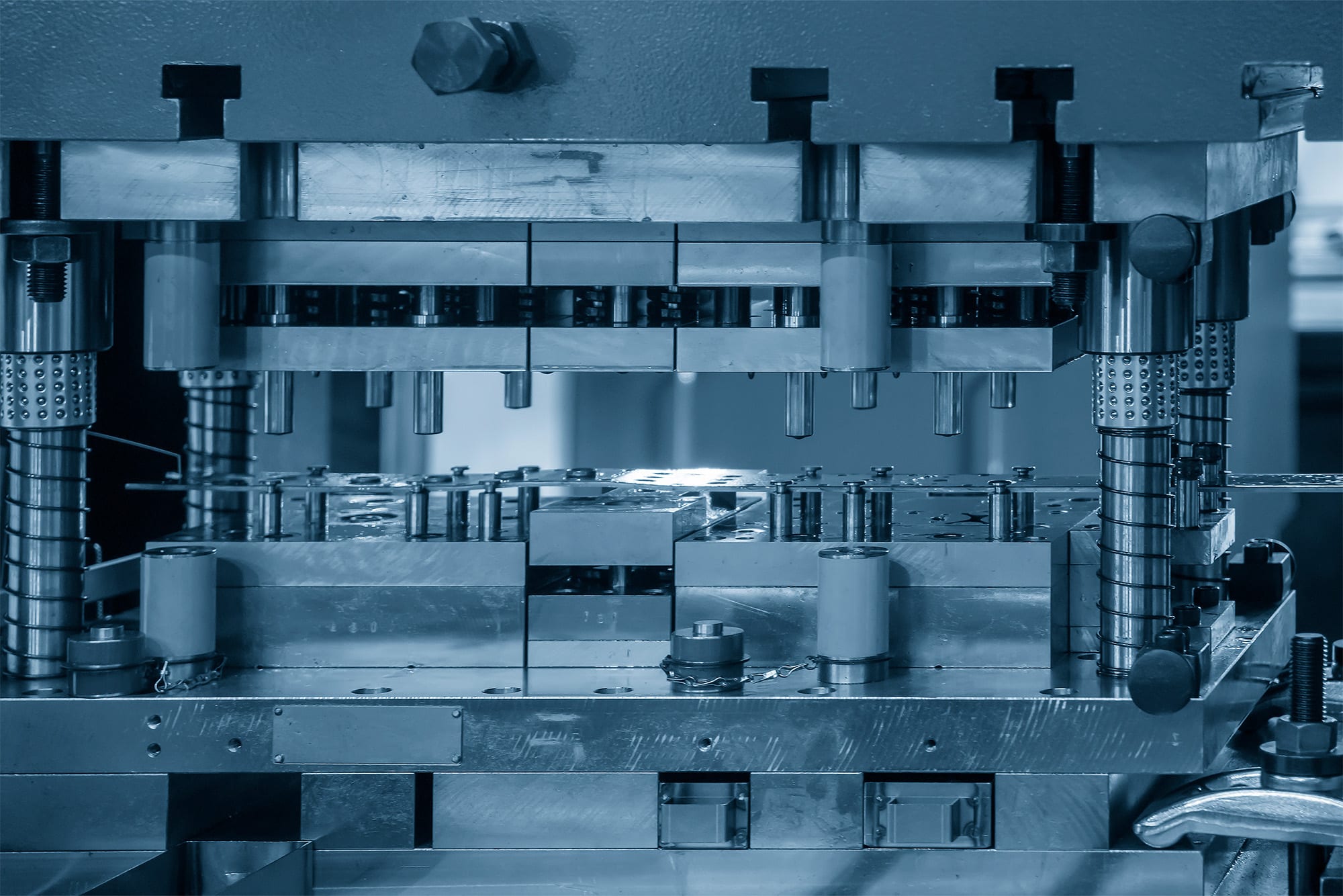 A progressive die made from tool steel, possibly coated showing tool steel's substrate compatibility